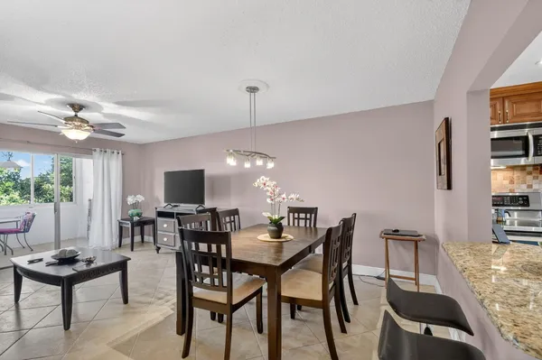 a view of a dining room with furniture and chandelier