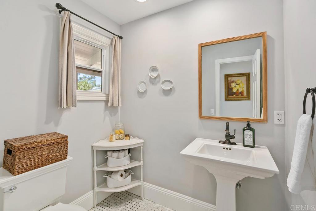 7880 Calle Dos Lagos Rancho Santa Fe, CA 92067 - Photo 15 of 44 a bathroom with a sink mirror and toilet