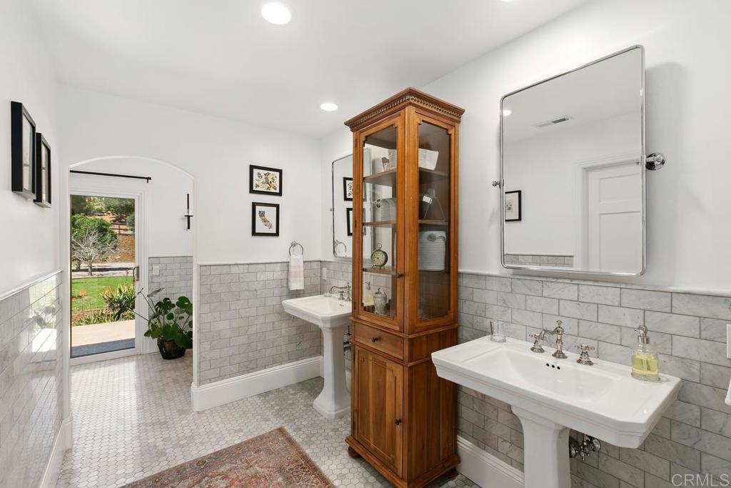 7880 Calle Dos Lagos Rancho Santa Fe, CA 92067 - Photo 17 of 44 a bathroom with a sink and a mirror