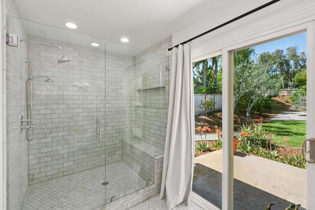 7880 Calle Dos Lagos Rancho Santa Fe, CA 92067 - Photo 18 of 44 a bathroom with a shower and a yard