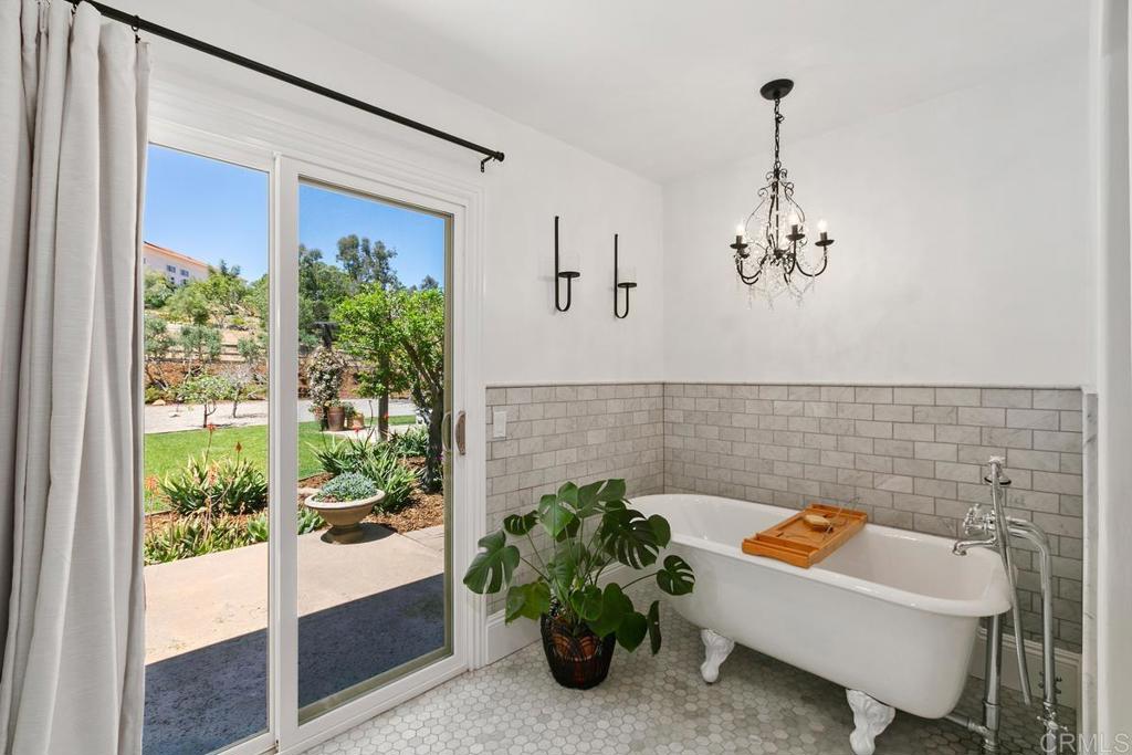 7880 Calle Dos Lagos Rancho Santa Fe, CA 92067 - Photo 19 of 44 a bathroom with a tub and window