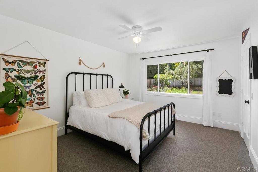 7880 Calle Dos Lagos Rancho Santa Fe, CA 92067 - Photo 20 of 44 a bedroom with a bed and a window