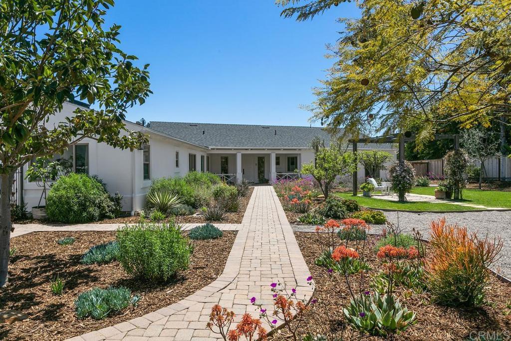 7880 Calle Dos Lagos Rancho Santa Fe, CA 92067 - Photo 2 of 44 front view of a house with a yard