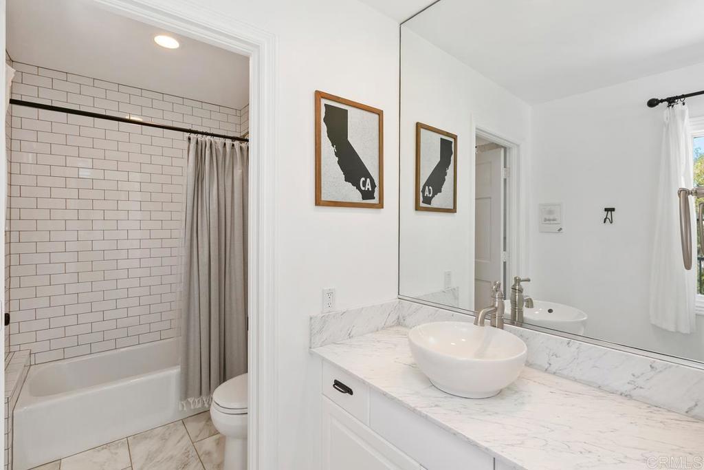7880 Calle Dos Lagos Rancho Santa Fe, CA 92067 - Photo 24 of 44 a bathroom with a granite countertop sink toilet and shower