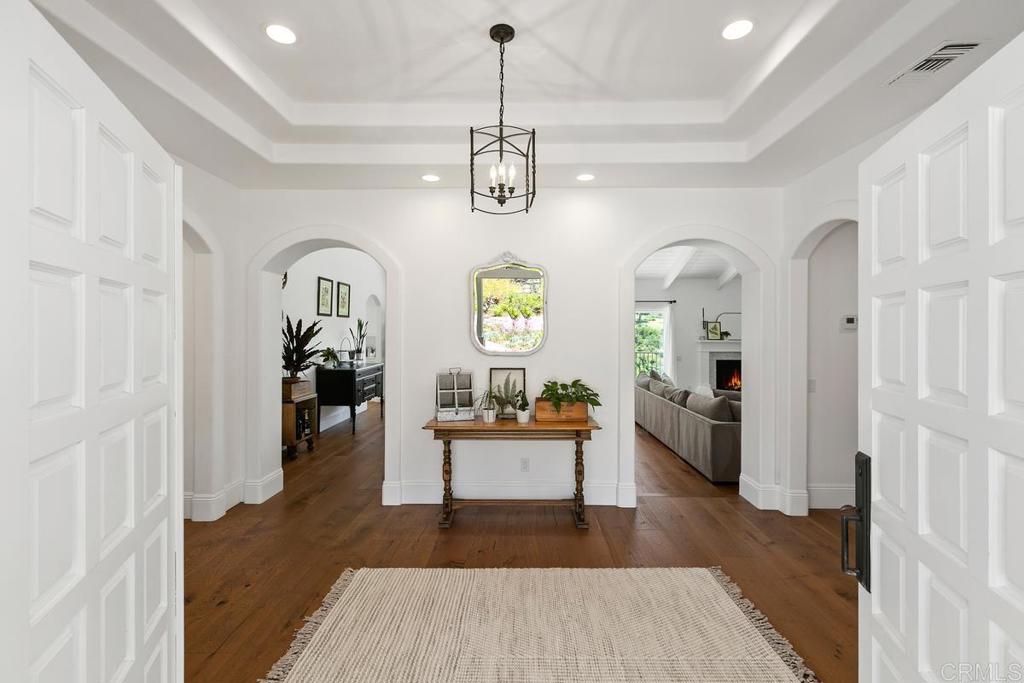 7880 Calle Dos Lagos Rancho Santa Fe, CA 92067 - Photo 3 of 44 a living room with dining table and wooden floor