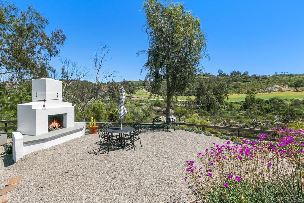 7880 Calle Dos Lagos Rancho Santa Fe, CA 92067 - Photo 34 of 44 a view of a chairs and table in the patio next to a yard