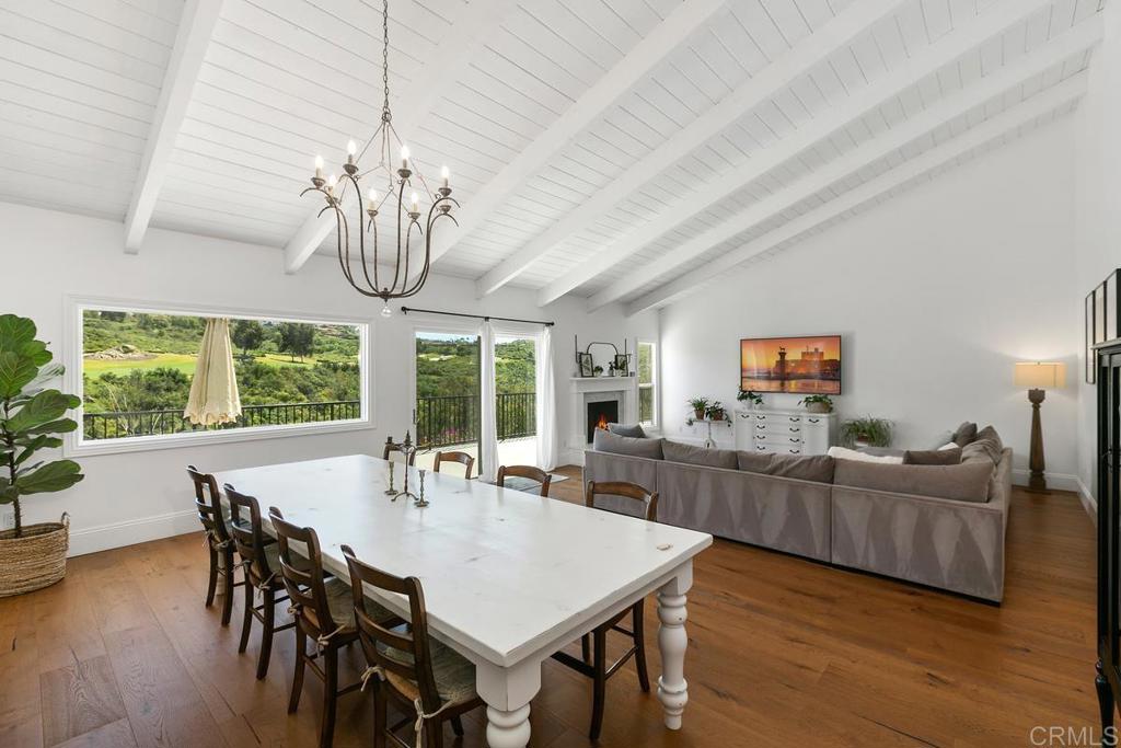 7880 Calle Dos Lagos Rancho Santa Fe, CA 92067 - Photo 4 of 44 a view of a dining room with furniture a chandelier and wooden floor