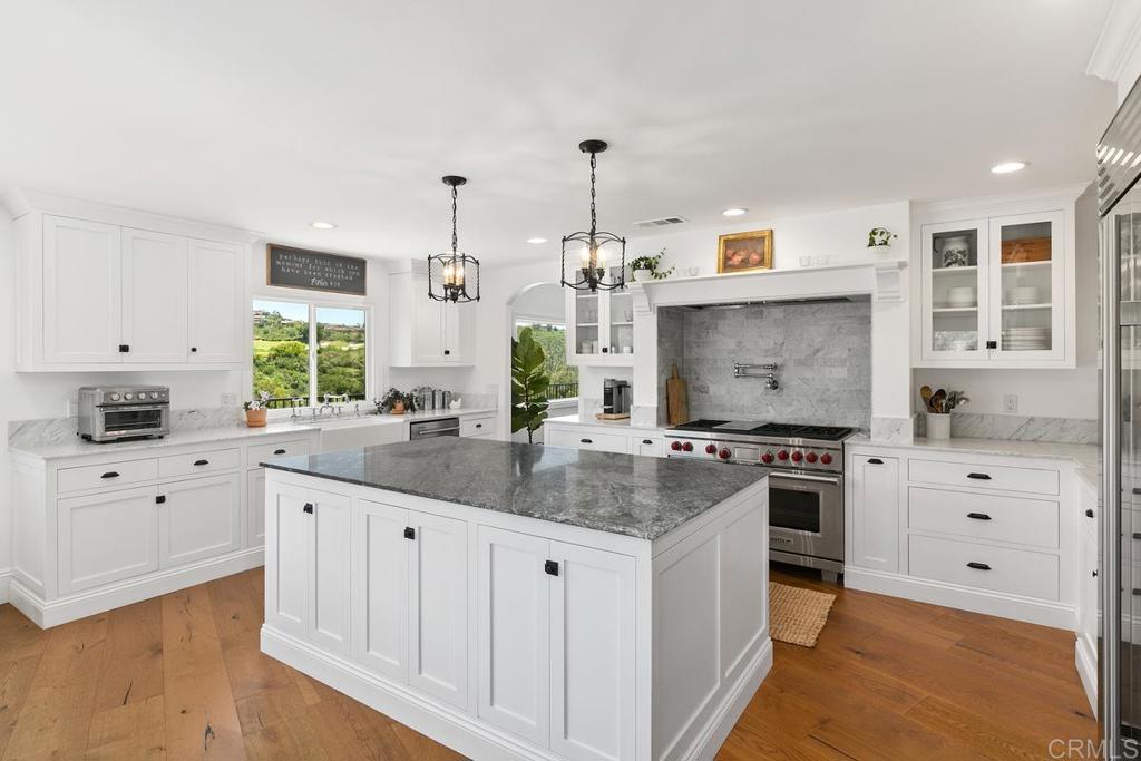 7880 Calle Dos Lagos Rancho Santa Fe, CA 92067 - Photo 7 of 44 a kitchen with stainless steel appliances granite countertop a sink stove and cabinets