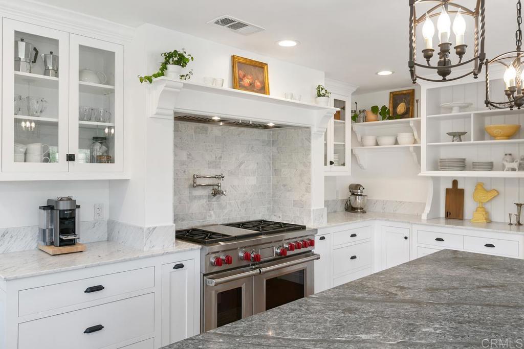 7880 Calle Dos Lagos Rancho Santa Fe, CA 92067 - Photo 8 of 44 a kitchen with a stove and cabinets