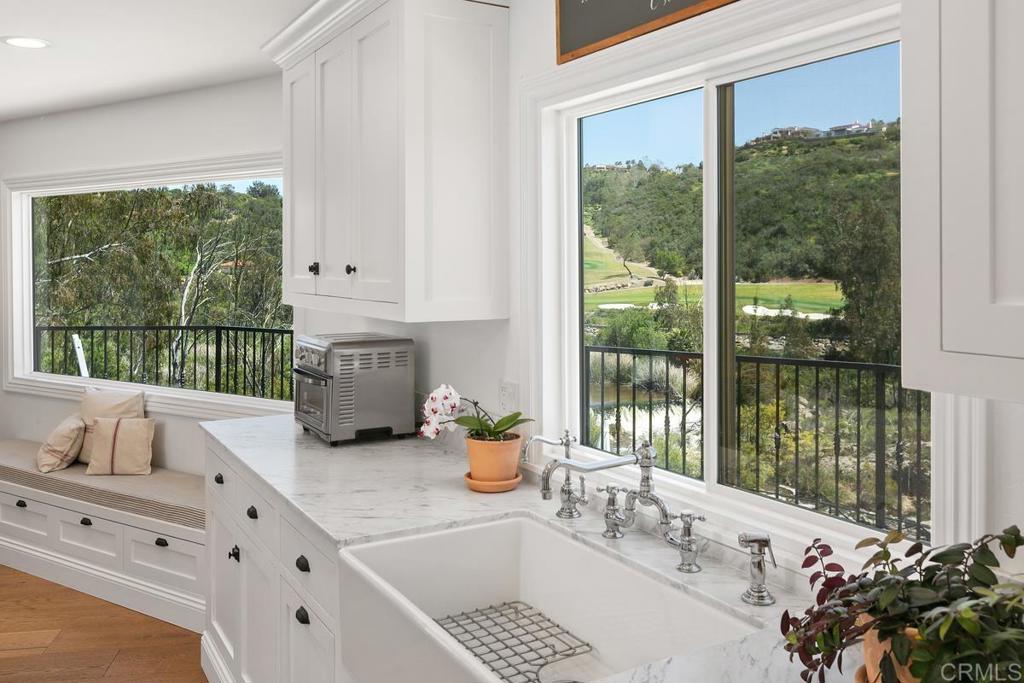 7880 Calle Dos Lagos Rancho Santa Fe, CA 92067 - Photo 9 of 44 a kitchen with granite countertop a large window and a sink
