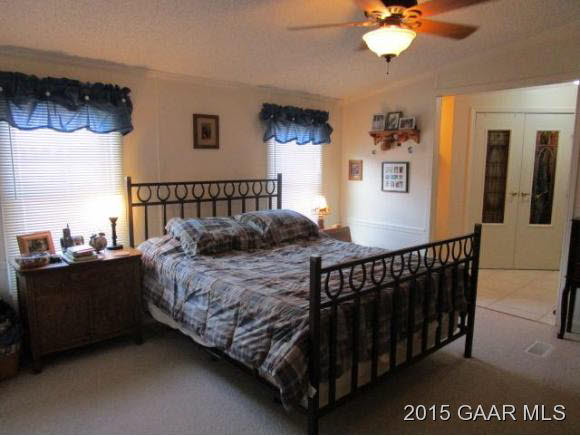 145 Humbert Road Crimora, VA 24431 - Photo 8 of 19 a bed sitting in a bedroom next to a window