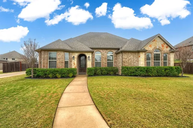 a front view of a house with yard