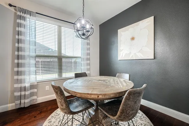 a kitchen with a table and chairs in it