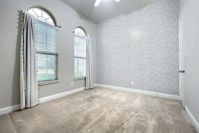 a spacious bathroom with a sink a vanity a mirror and shower
