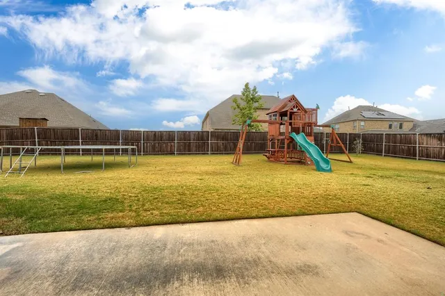 a living room with furniture a flat screen tv and a potted plant