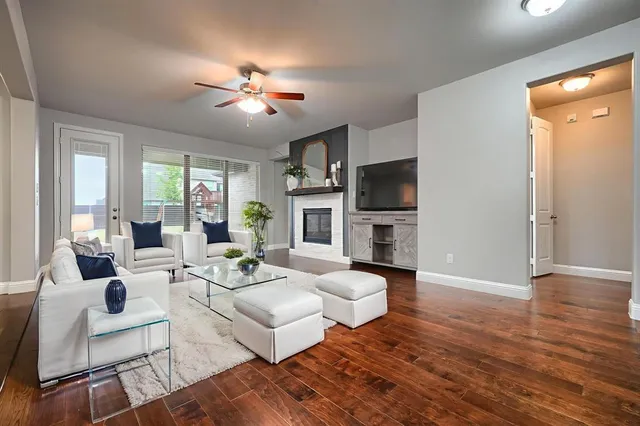 a living room with fireplace furniture and a flat screen tv