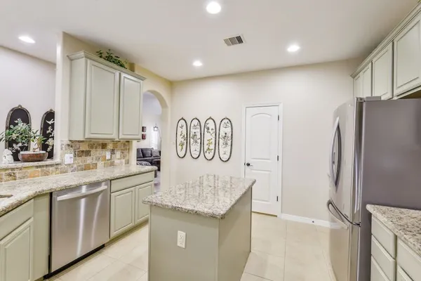a kitchen with a refrigerator and a sink