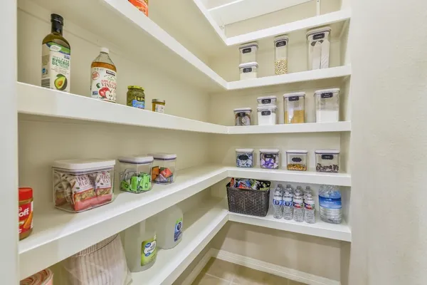 a cabinet with fridge and lots of clutter
