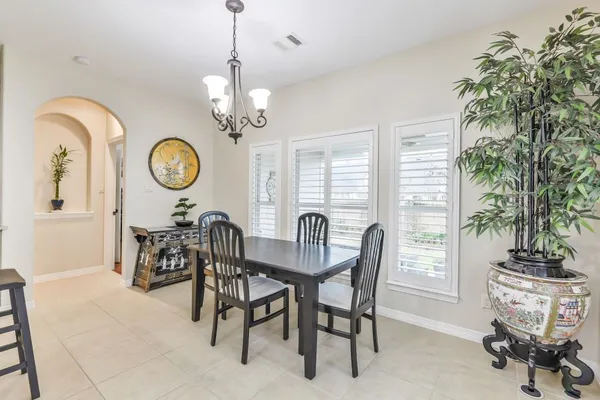 a view of a dining room with furniture and a large window