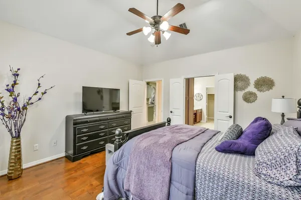 a bedroom with a bed and a flat screen tv