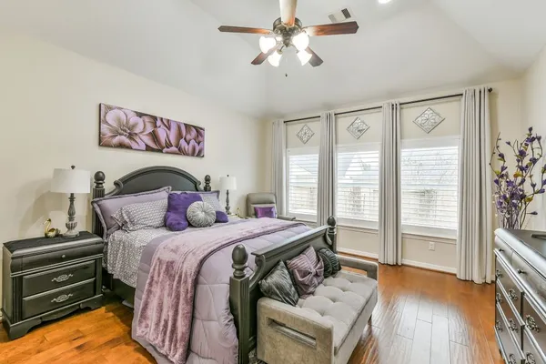 a bedroom with a bed and a chandelier