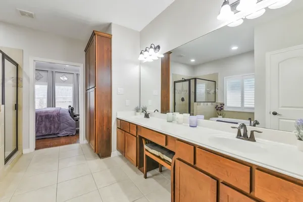 a bathroom with a sink double vanity and a mirror