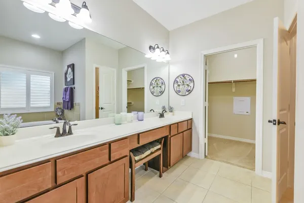 a bathroom with a sink double vanity and a mirror