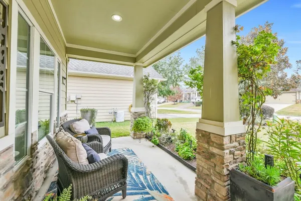 a balcony with furniture and a potted plant