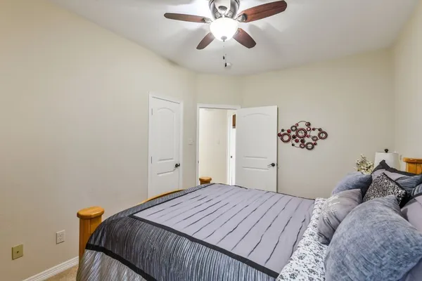 a bedroom with a bed and a chandelier