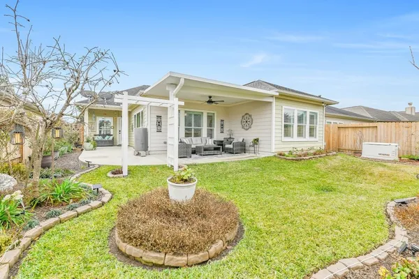 a view of a house with a backyard porch and sitting area
