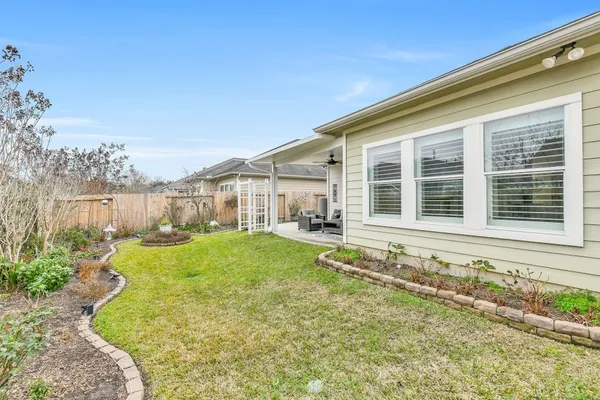 a view of a house with backyard and sitting area