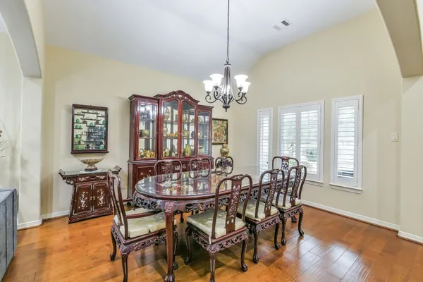 a view of a dining room with furniture and window