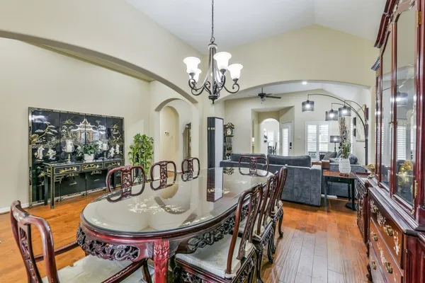 a view of a dining room with furniture and wooden floor