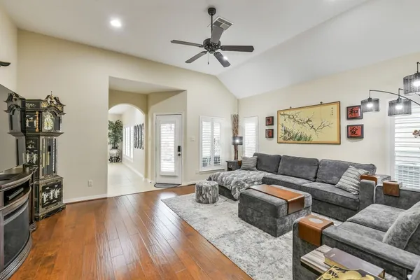 a living room with furniture and a wooden floor