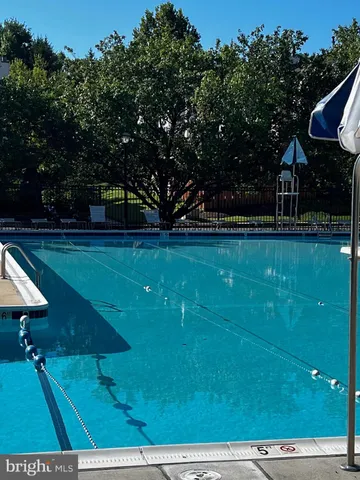 a tennis court with view of trees in the background
