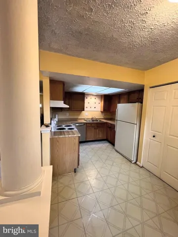 a kitchen with granite countertop a sink and a stove top oven