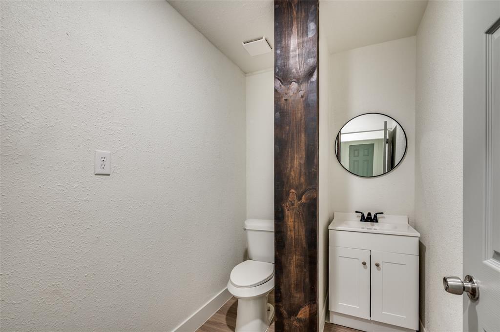 107 McArthur Lane Cleburne, TX 76031 - Photo 12 of 26 a bathroom with a toilet and a sink