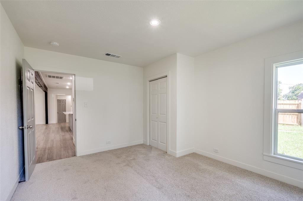 107 McArthur Lane Cleburne, TX 76031 - Photo 14 of 26 an empty room with windows and closet