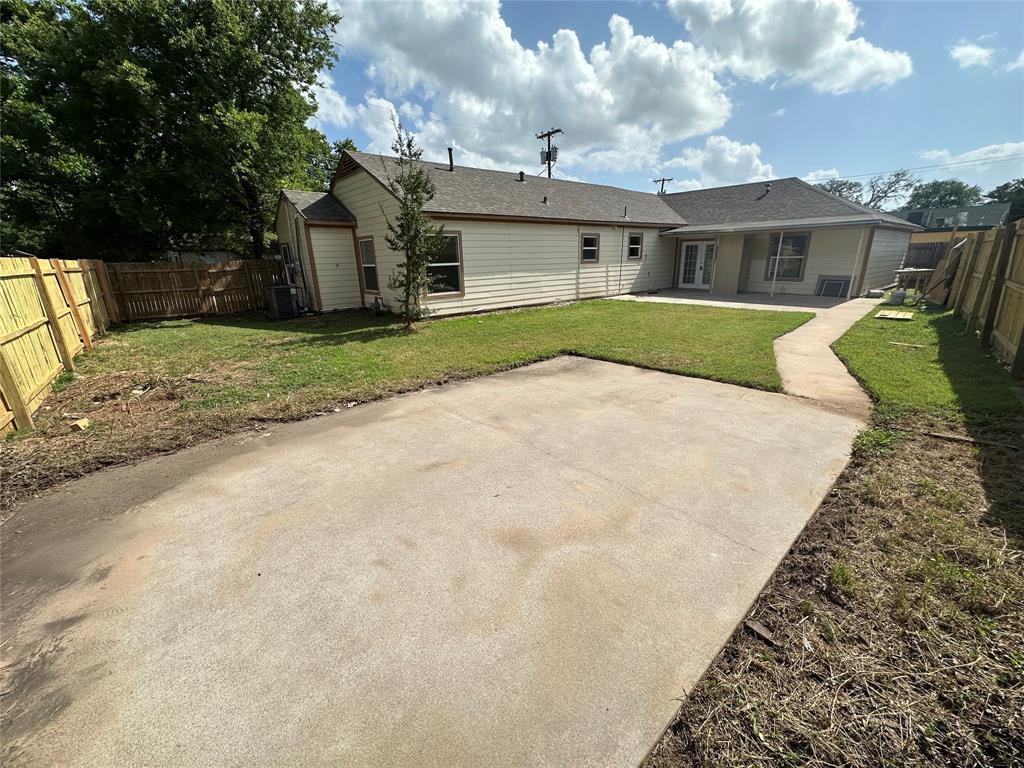 107 McArthur Lane Cleburne, TX 76031 - Photo 24 of 26 a view of a white house next to a yard with big trees