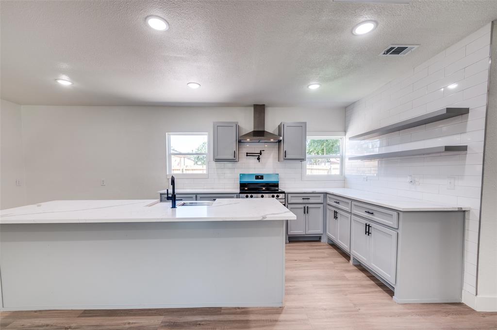 107 McArthur Lane Cleburne, TX 76031 - Photo 3 of 26 a large kitchen with stainless steel appliances lots of counter space and a sink