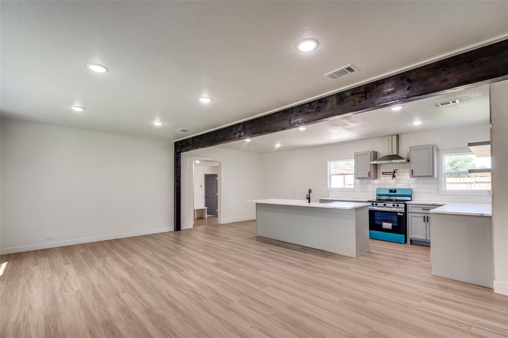 107 McArthur Lane Cleburne, TX 76031 - Photo 6 of 26 a large kitchen with stainless steel appliances granite countertop a large center island and a sink