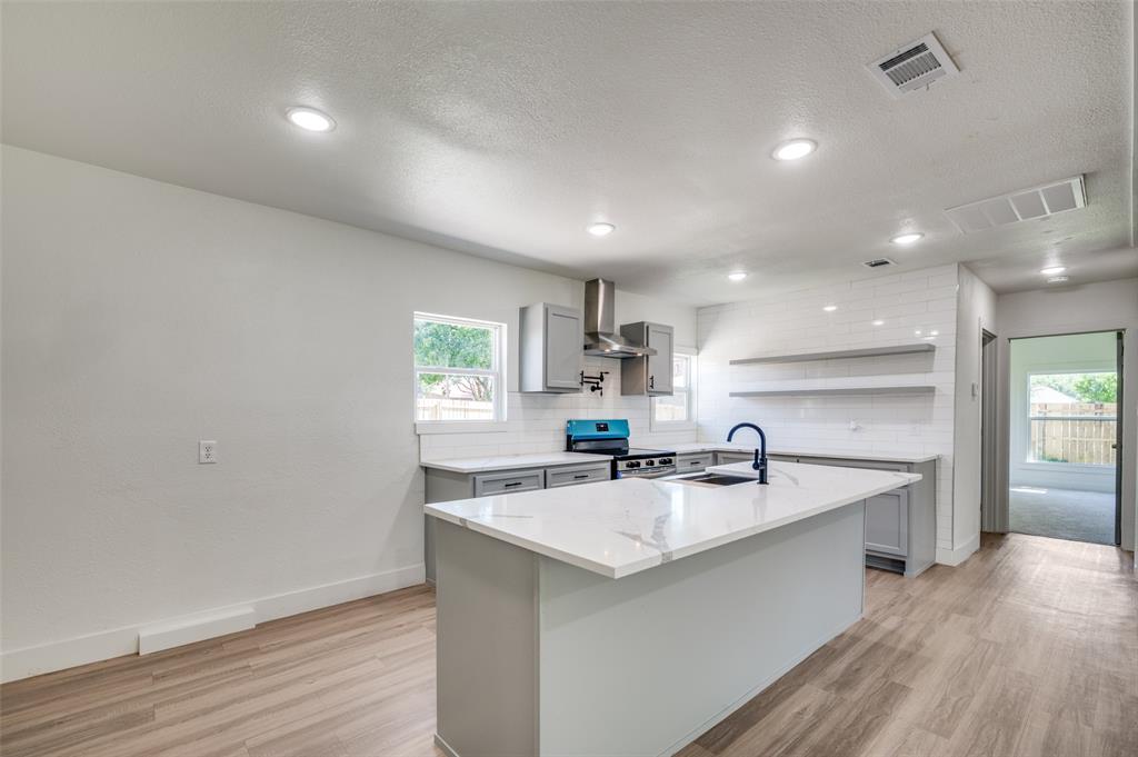 107 McArthur Lane Cleburne, TX 76031 - Photo 8 of 26 a kitchen with stainless steel appliances a sink stove and cabinets