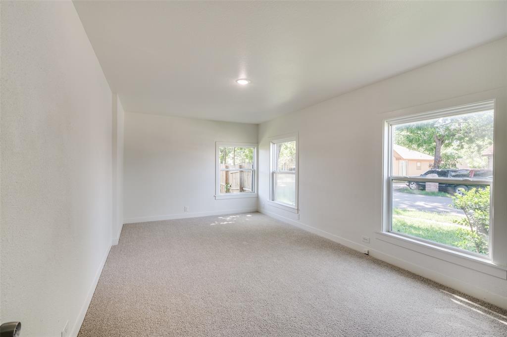 107 McArthur Lane Cleburne, TX 76031 - Photo 9 of 26 a view of a big room with windows and chandelier fan