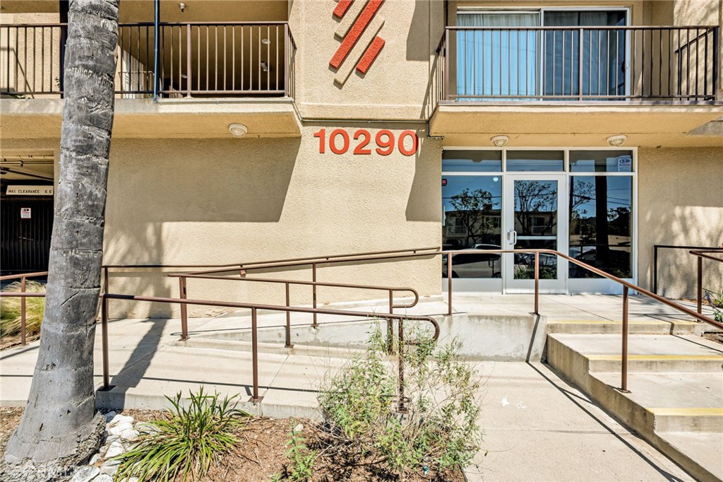 a view of a balcony with a potted plant on the wall