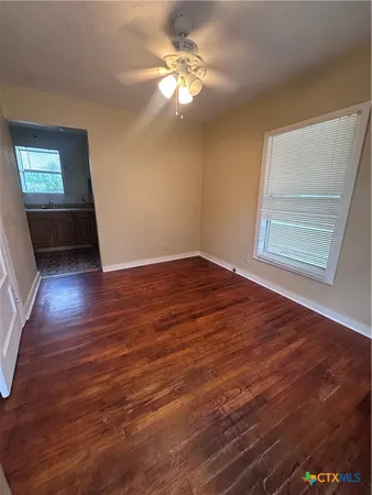 wooden floor in an empty room with a window
