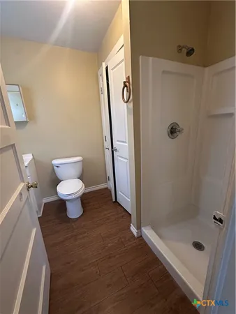 a bathroom with a shower toilet and sink