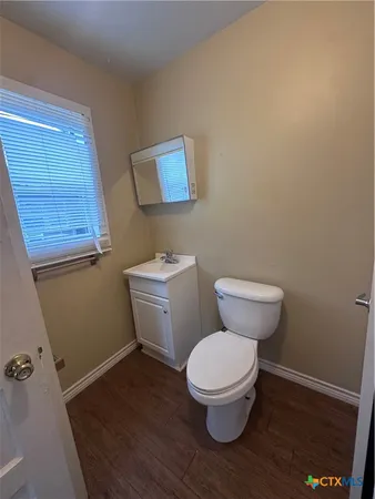 a white toilet sitting next to a bathroom sink