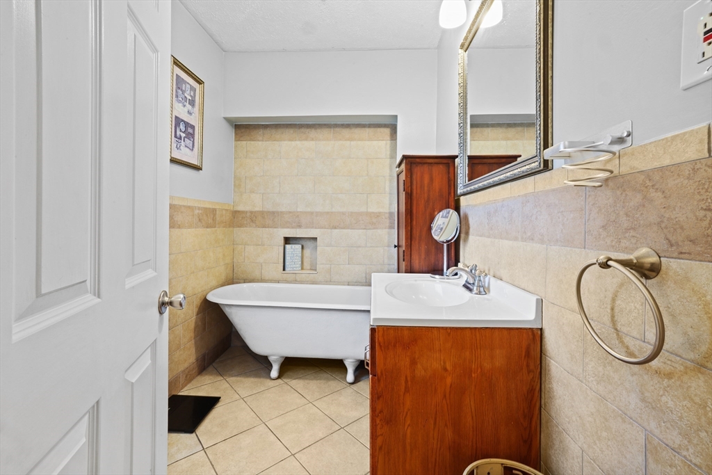 161 Foster Street Fall River, MA 02721 - Photo 11 of 20 a bathroom with a sink and a mirror