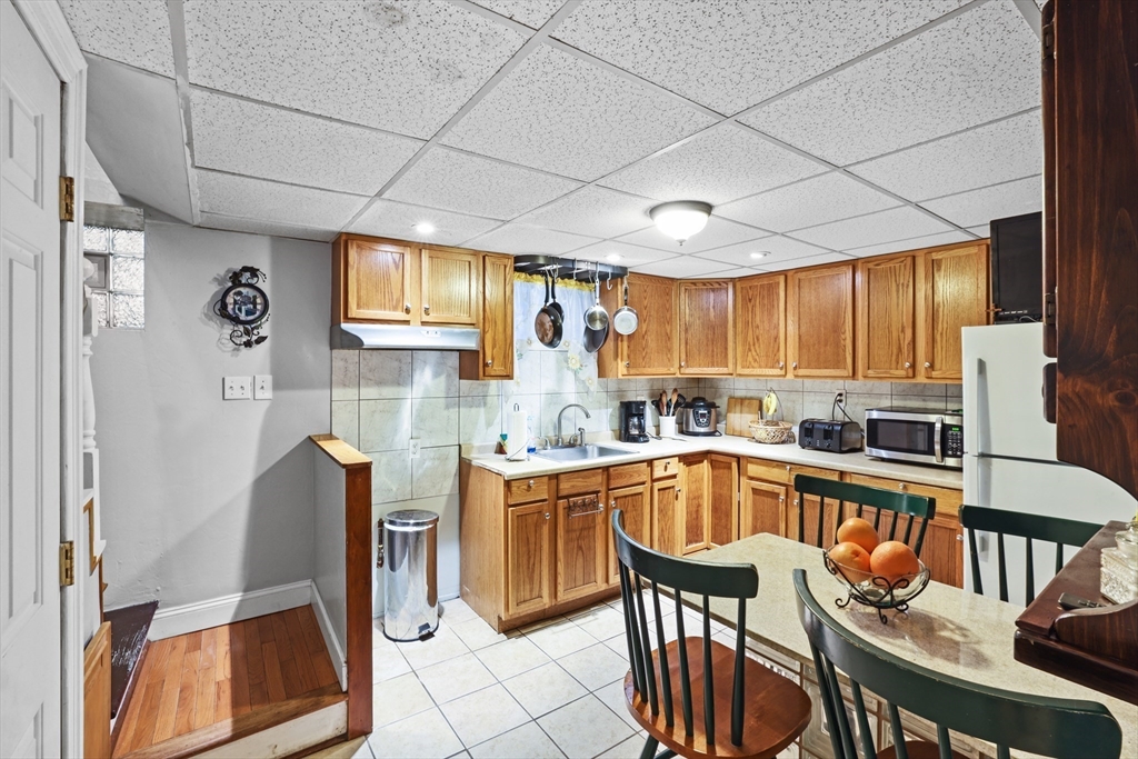 161 Foster Street Fall River, MA 02721 - Photo 17 of 20 a kitchen with stainless steel appliances granite countertop a stove a sink dishwasher and cabinets