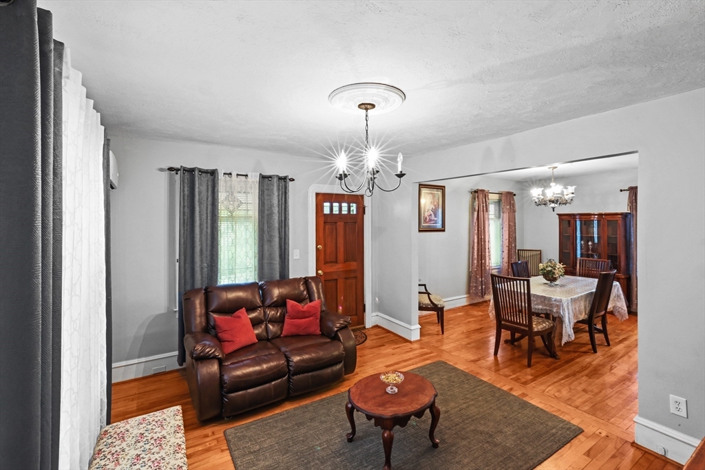 161 Foster Street Fall River, MA 02721 - Photo 8 of 20 a living room with furniture a chandelier and a dining table